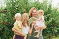 Portrait of happy young family with two little children enjoying good time in apple orchard Royalty Free Stock Photo