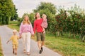 Portrait of happy young family with two little children enjoying good time in apple orchard Royalty Free Stock Photo