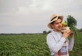 Portrait of a happy young farmer holding fresh vegetables in a basket. On a background of nature The concept of biological, bio Royalty Free Stock Photo