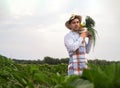 Portrait of a happy young farmer holding fresh vegetables in a basket. On a background of nature The concept of biological, bio Royalty Free Stock Photo