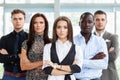 Portrait of a happy young female business leader standing in front of her team. Royalty Free Stock Photo