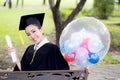 Portrait of happy young female graduates in academic dress and square academic cap Royalty Free Stock Photo