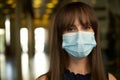 Portrait of happy young female office worker in office building hallway, wearing face mask Royalty Free Stock Photo