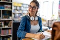 Portrait of happy young female studying in a library. Education study teenager concept Royalty Free Stock Photo
