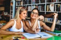 Portrait of happy young people studying together in a library. Education study teenager concept Royalty Free Stock Photo