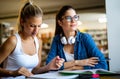 Portrait of happy young people studying together in a library. Education study teenager concept Royalty Free Stock Photo