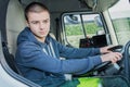 Portrait happy young garbage truck driver