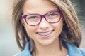 Portrait of happy young girl with dental braces and glasses Royalty Free Stock Photo