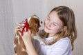 Portrait happy young girl holding cute Purebred puppy Cavalier King Charles Spaniel with red bow Royalty Free Stock Photo