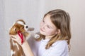 Portrait happy young girl holding cute Purebred puppy Cavalier King Charles Spaniel with red bow Royalty Free Stock Photo