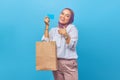 Portrait of happy young girl holding shopping bag and credit card Royalty Free Stock Photo