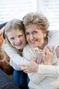 Portrait of happy young girl hugging grandmother