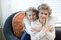 Portrait of happy young girl hugging grandmother