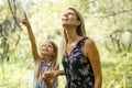 Portrait of a happy young girl outdoors forest with babysitter