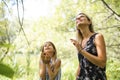 Portrait of a happy young girl outdoors forest with babysitter Royalty Free Stock Photo