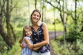 Portrait of a happy young girl outdoors forest with babysitter Royalty Free Stock Photo