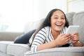 Who needs a tv when Ive got my tablet. Portrait of a happy young girl relaxing on the sofa and using a digital tablet. Royalty Free Stock Photo