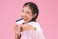 portrait of happy young girl showing credit card over pink background,easy Business concept.