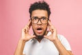 Portrait of happy young good-looking tan-skinned male student with afro hairstyle in casual, looking in camera with excited face Royalty Free Stock Photo