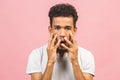 Portrait of happy young good-looking tan-skinned male student with afro hairstyle in casual smiling, looking in camera with Royalty Free Stock Photo