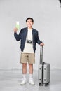 Portrait of happy young guy holding passport and boarding pass against white background Royalty Free Stock Photo