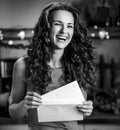 Happy young housewife with christmas letter in kitch Royalty Free Stock Photo