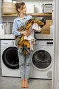 Portrait of a happy young housewife with clean clothes