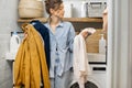 Portrait of a happy young housewife with clean clothes