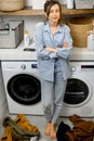 Portrait of a happy young housewife with clean clothes