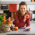 Portrait of happy housewife holding grocery shopping check Royalty Free Stock Photo