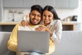 Portrait Of Happy Young Indian Spouses Relaxing With Laptop At Home Royalty Free Stock Photo