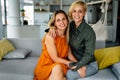 Portrait of happy lesbian couple embracing each other and smiling in living room Royalty Free Stock Photo