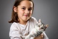 Portrait of happy young little girl with calico kitten cat Royalty Free Stock Photo