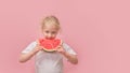 portrait happy young little girl is holding slice of watermelon over colorful pink background Royalty Free Stock Photo
