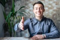 Portrait of happy young male hr stretching hand inviting you spectator to join corporate team, friendly capable manager looking at Royalty Free Stock Photo