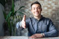 Portrait of happy young male hr stretching hand inviting you spectator to join corporate team, friendly capable manager looking at Royalty Free Stock Photo