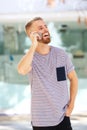 Happy young man with beard talking on mobile phone Royalty Free Stock Photo