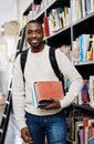 Im book smart and confident. Portrait of a happy young man carrying books in a library at college. Royalty Free Stock Photo