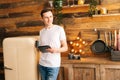 Portrait of happy young man in casual clothes using digital tablet. Royalty Free Stock Photo