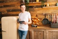 Portrait of happy young man in casual clothes using digital tablet. Royalty Free Stock Photo
