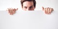 Portrait Of Happy Young Man Holding Blank White Card With Copy Space Standing Against White Wall Royalty Free Stock Photo