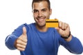 Portrait of happy young man, holding empty credit card and showing thumbs up Royalty Free Stock Photo