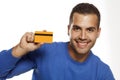 Portrait of happy young man, holding empty credit card on white Royalty Free Stock Photo