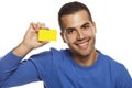 Portrait of happy young man, holding empty credit card on white Royalty Free Stock Photo