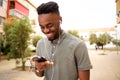 Happy young man listening to music with smart phone Royalty Free Stock Photo