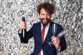 Happy young man holding glasses and champagne bottle Royalty Free Stock Photo