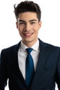 portrait of happy young man in navy blue suit looking forward and smiling Royalty Free Stock Photo