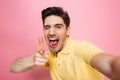 Portrait of a happy young man pointing finger Royalty Free Stock Photo