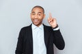 Portrait of a happy young man pointing finger up Royalty Free Stock Photo