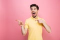 Portrait of a happy young man pointing fingers away Royalty Free Stock Photo